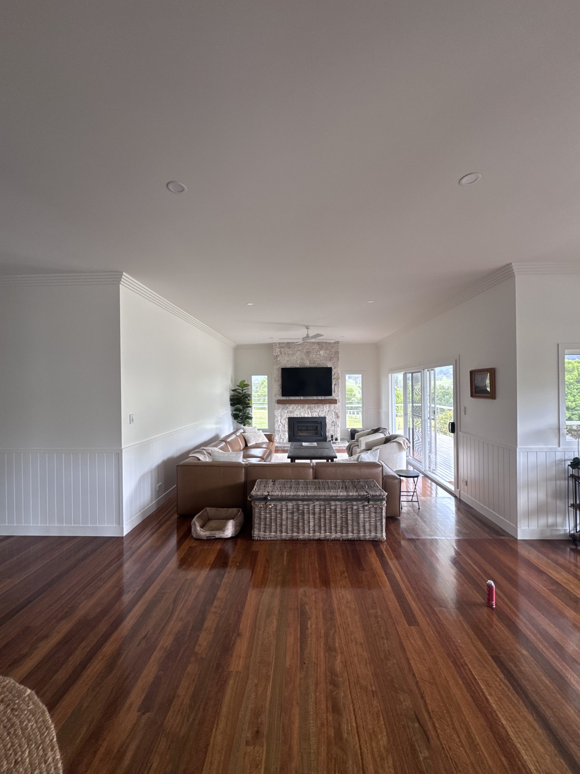 White walls and ceiling in a living room with timber flooring